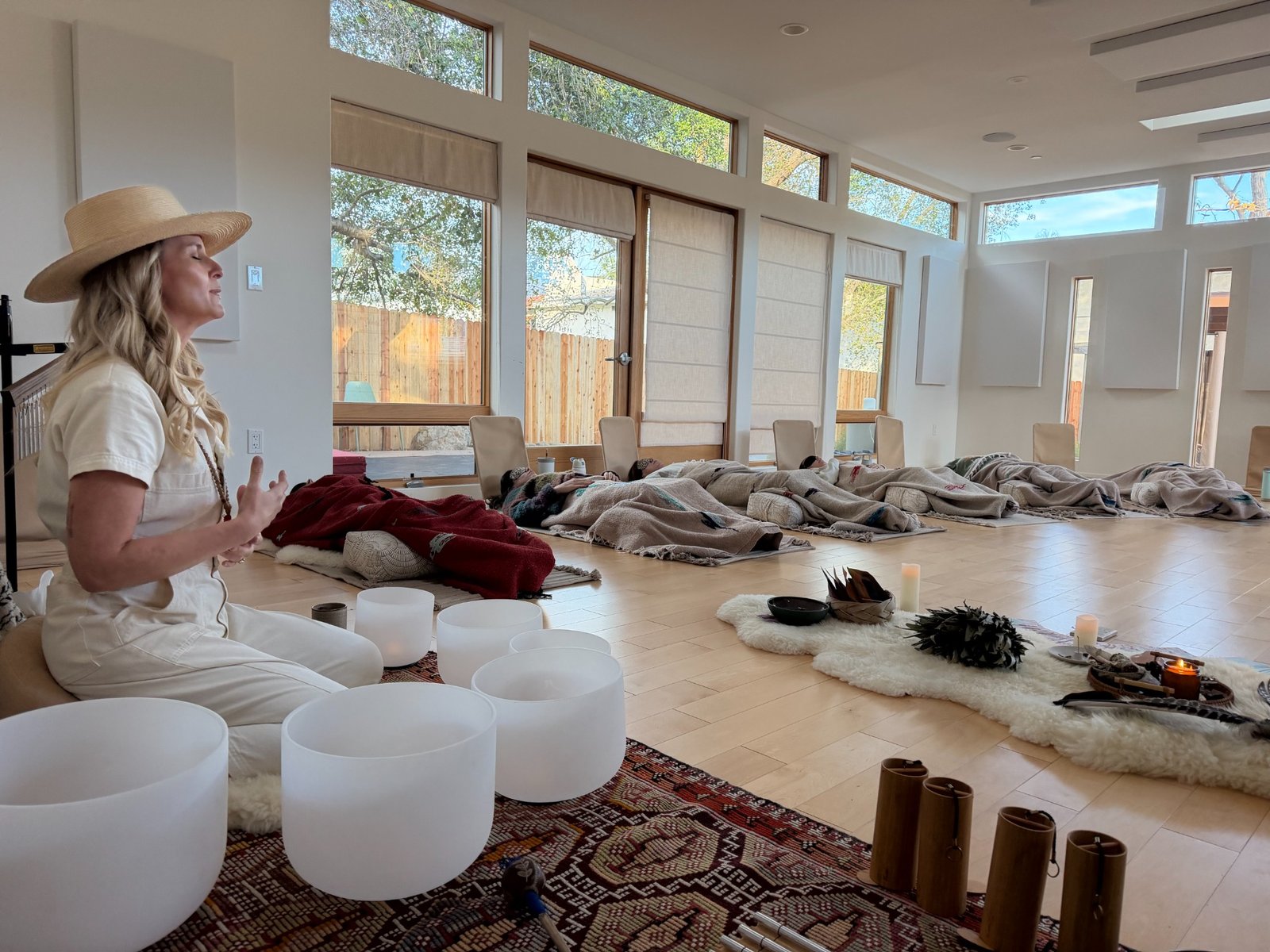 Kali guiding a breathwork journey with singing bowls