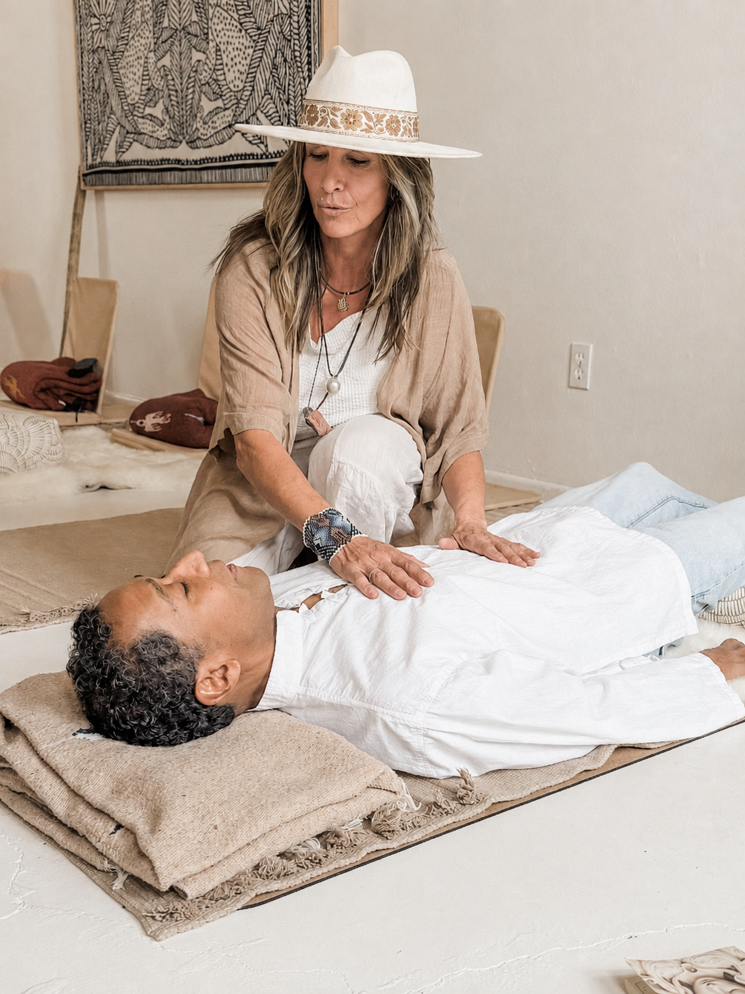 A Ritual Breathwork facilitator supporting a client during studio training