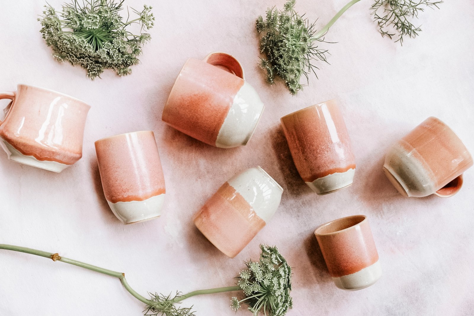 Blush pink handmade mugs and tumblers from the Pink Moment Collection styled with airy flowers