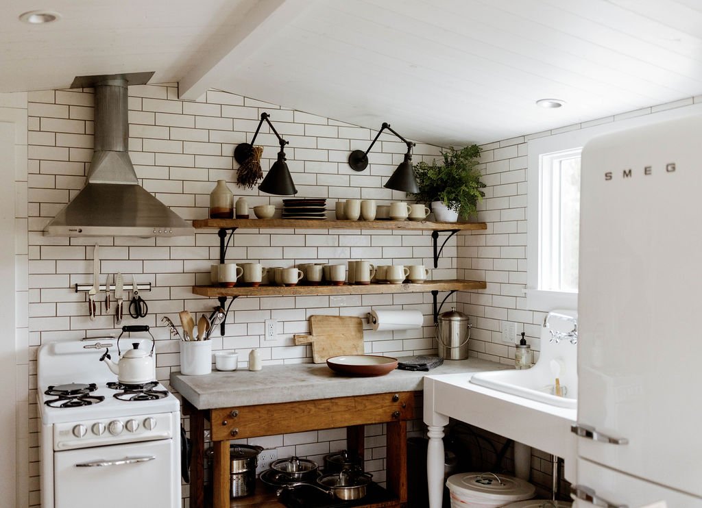 A warm working kitchen filled with handmade ceramics and natural materials