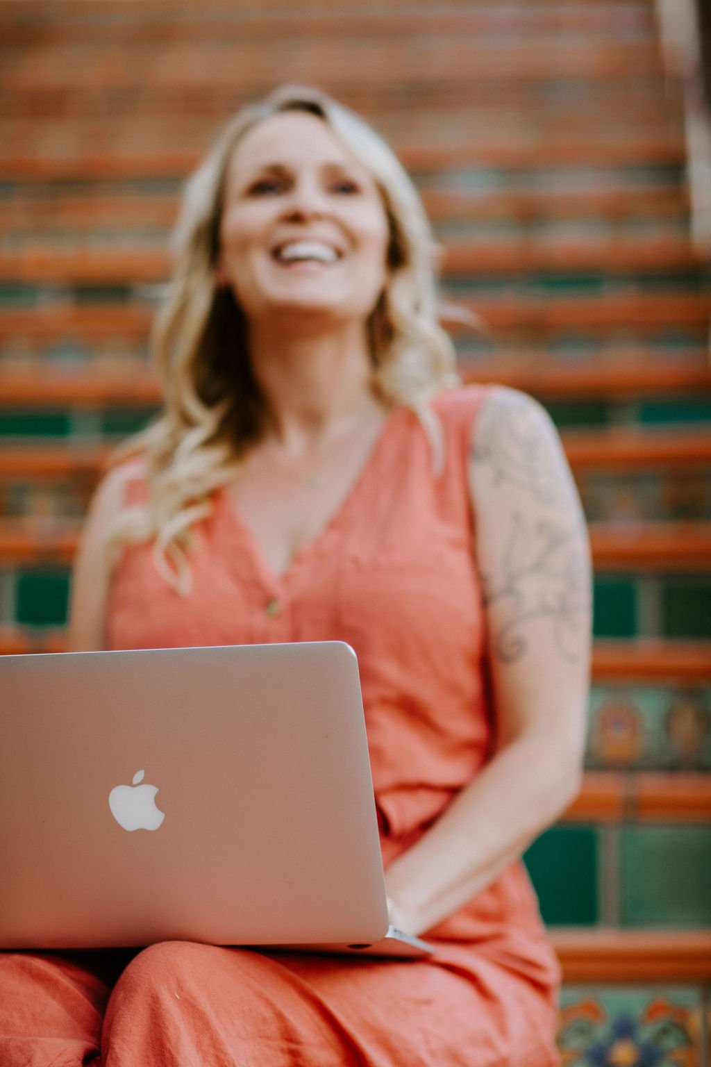 Kali May working beside her laptop