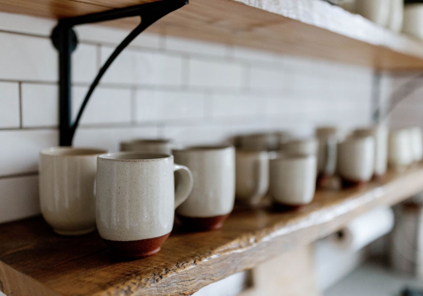 Cream-glazed Ojai Collection mugs and dinnerware with exposed red clay details
